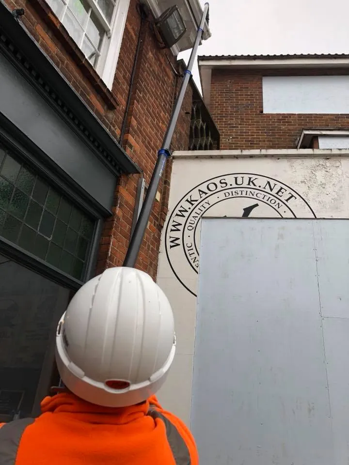 a person wearing a hard hat standing in front of a building