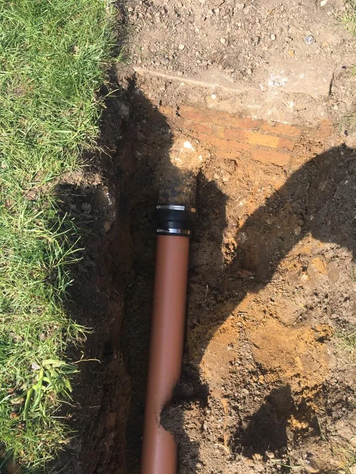 a pipe laying on the ground in the dirt